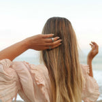 Woman on beach wearing silver spinner meditation ring