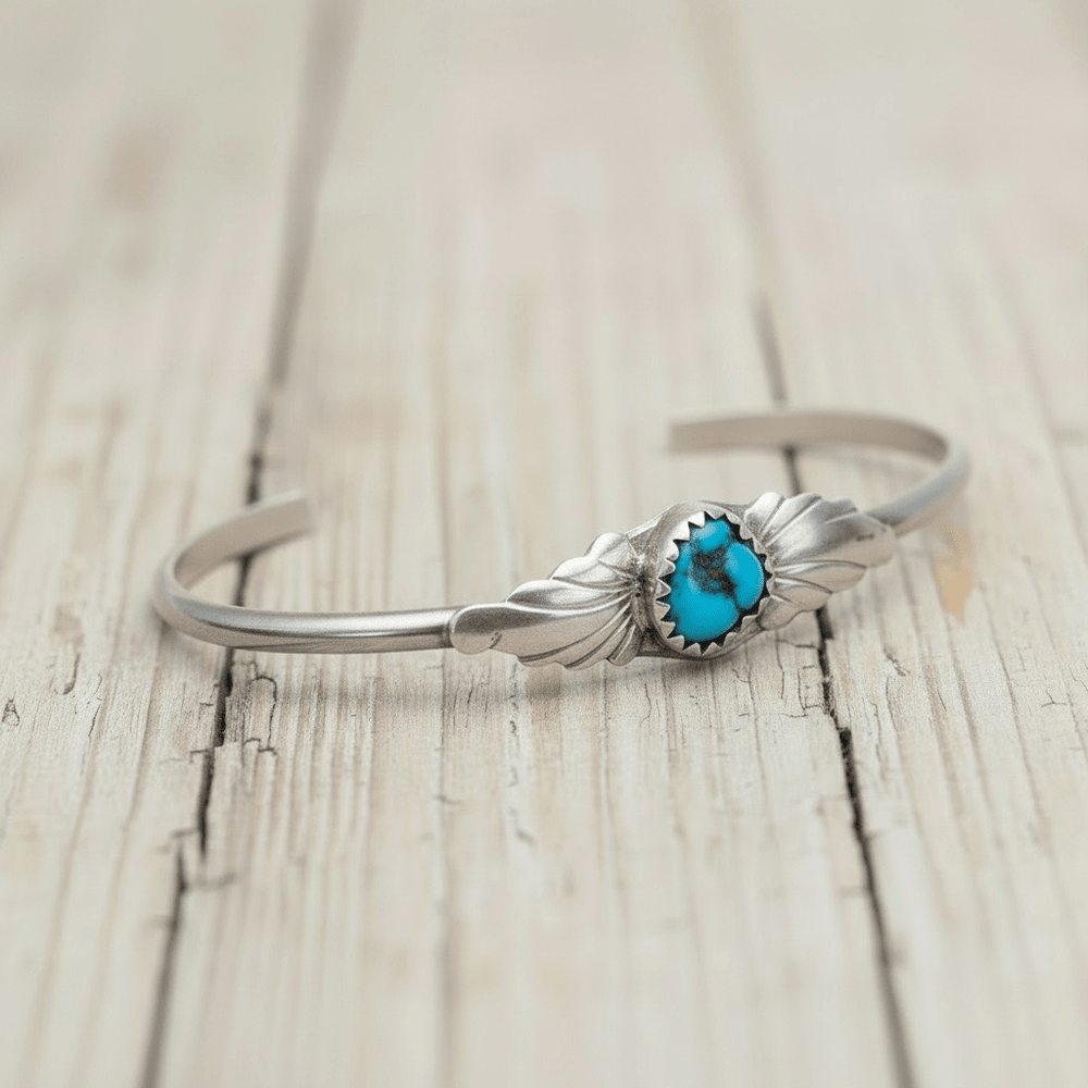 Silver sterling turquoise bracelet with a natural turquoise stone on a white background