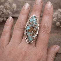 Turquoise ring on a hand with a natural background