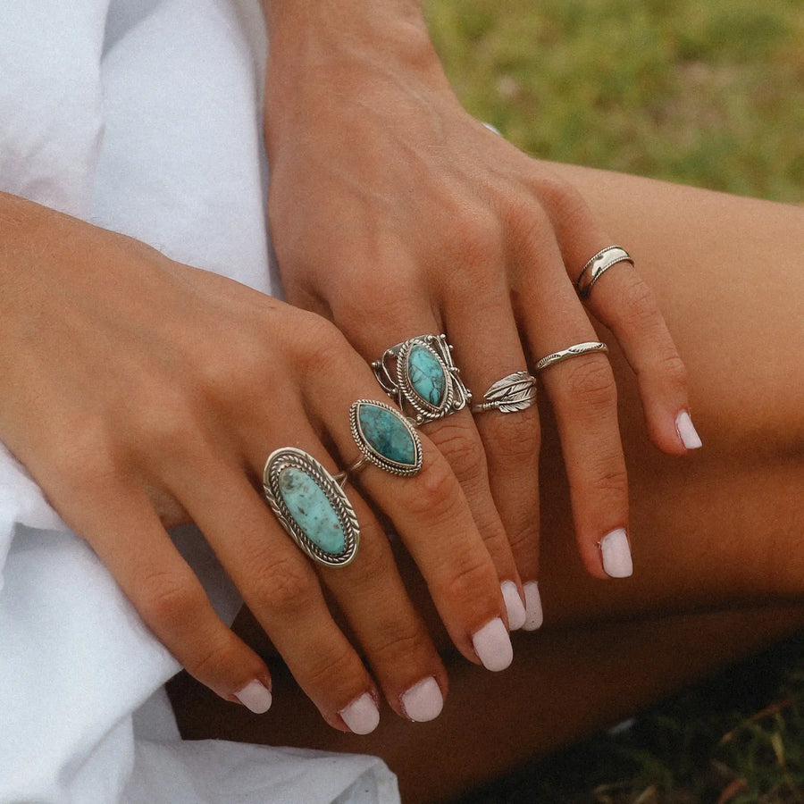 woman with large sterling silver and turquoise statement rings - turquoise jewellery 
