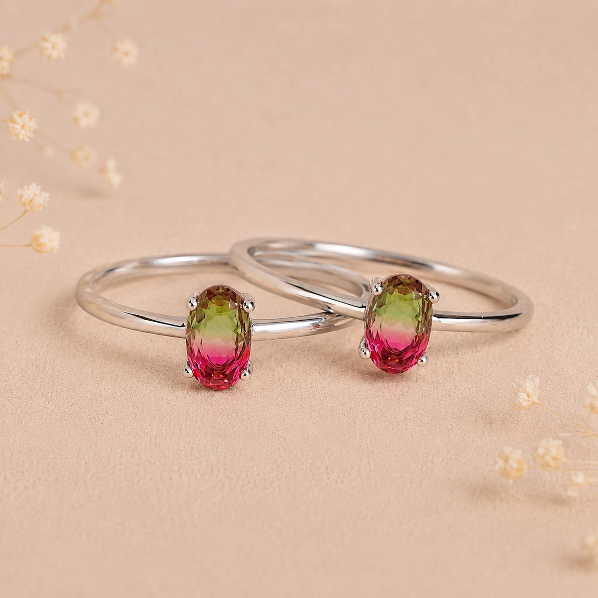 two sterling silver oval watermelon tourmaline ring with green and pink colours on a light background
