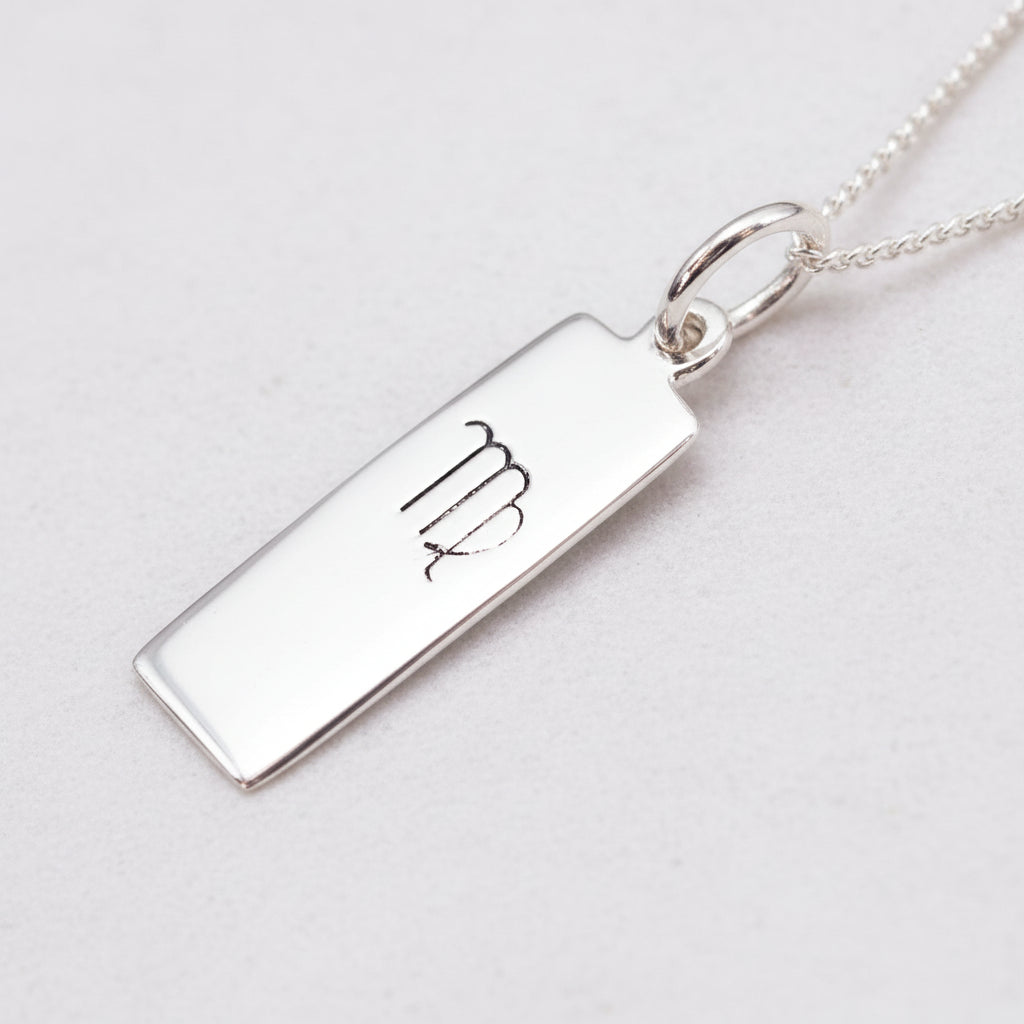virgo zodiac necklace in sterling silver on a white surface