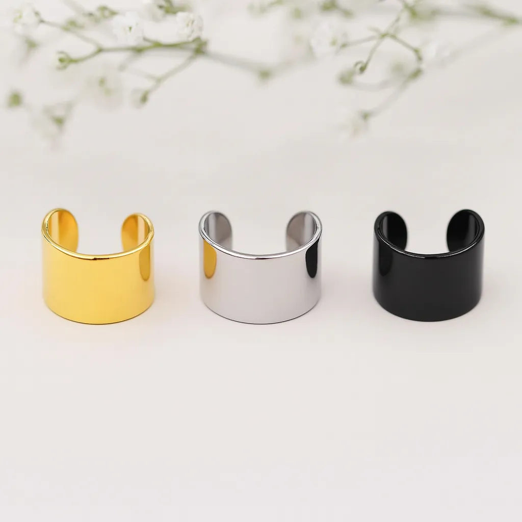 Three ear cuffs in gold, silver, and black on a light background. waterproof jewellery australia by indie and harper