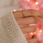 hand wearing stainless steel waterproof twisted rose gold stacker ring