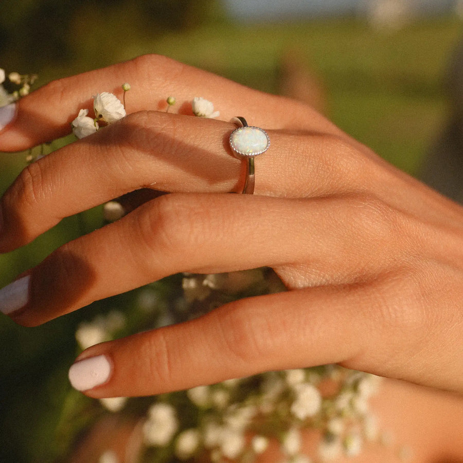 woman wearing sterling silver oval opal ring