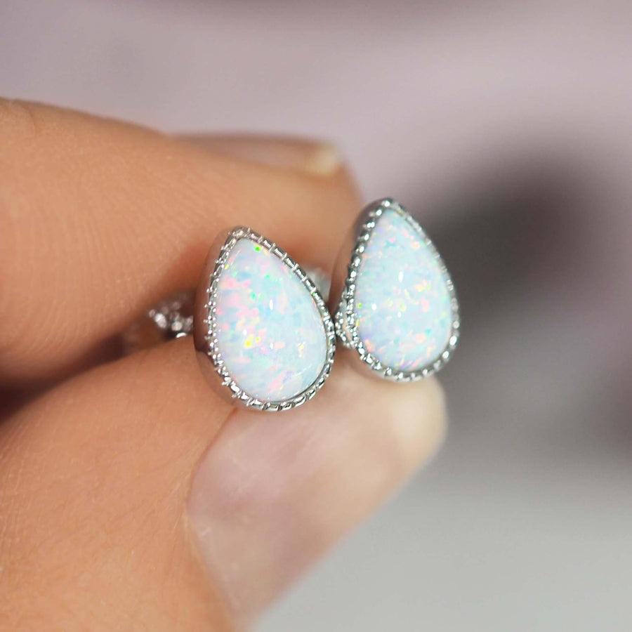 fingers holding White Opal Earrings - womens opal jewellery by indie and harper