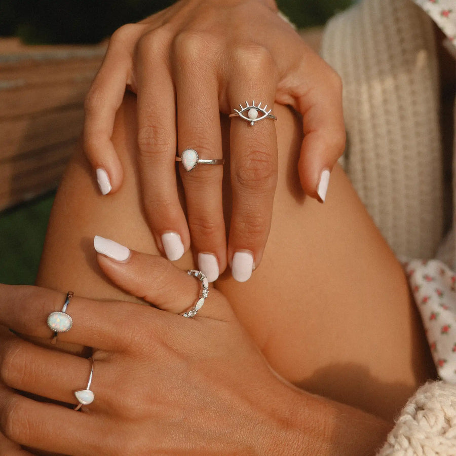 woman wearing five sterling silver rings with opals