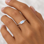 White Topaz and Moonstone Ring in polished sterling silver worn on a woman's hand