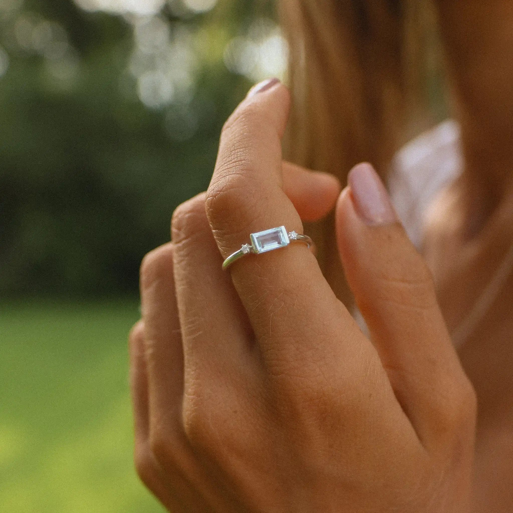 woman wearing sterling silver white topaz and aquamarine ring - indie and Harper 