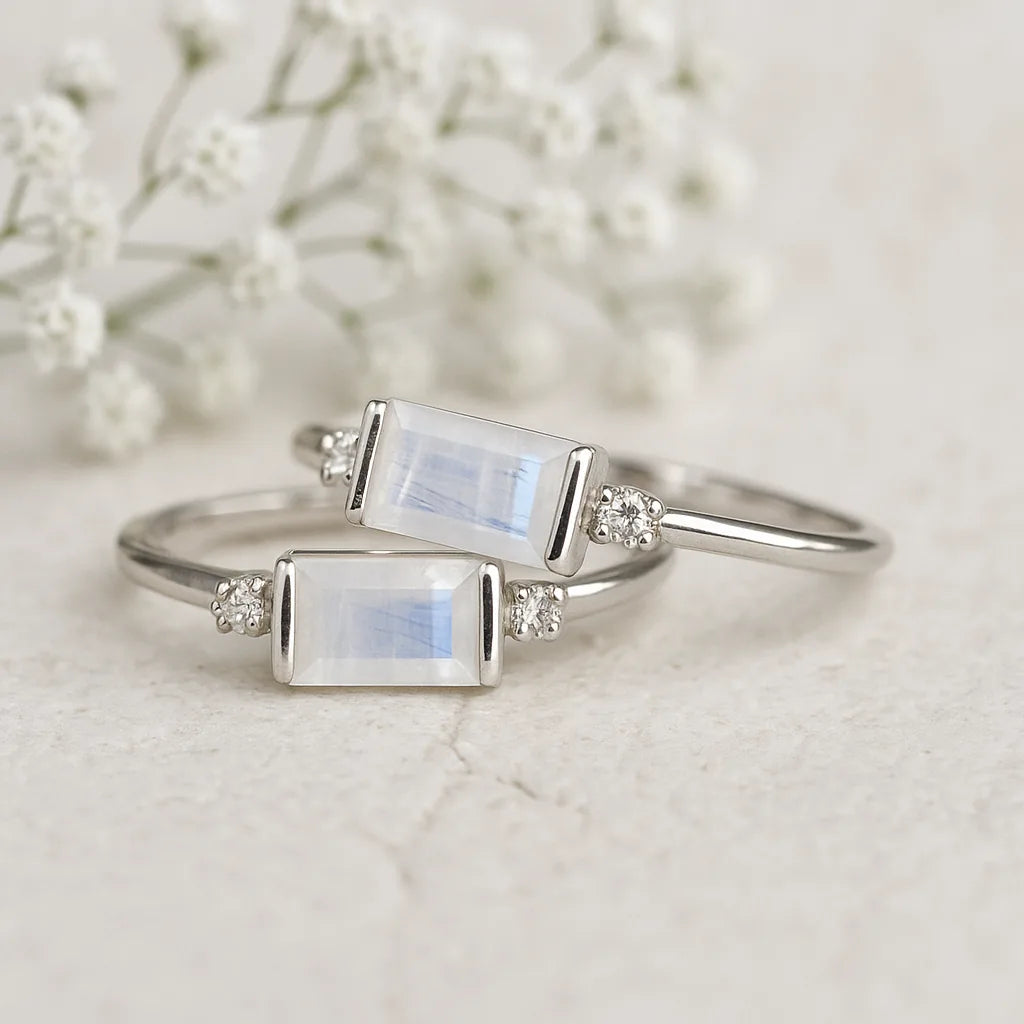 Two silver rings with moonstone stones on a light background