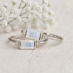Two silver rings with moonstone stones on a light background