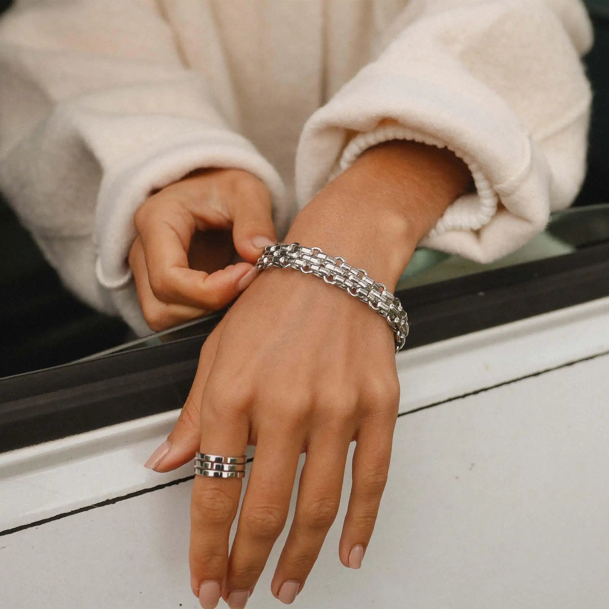 woman wearing a Waterproof chunky silver chain bracelet in stainless steel with interlocking links, designed for everyday wear and stacking