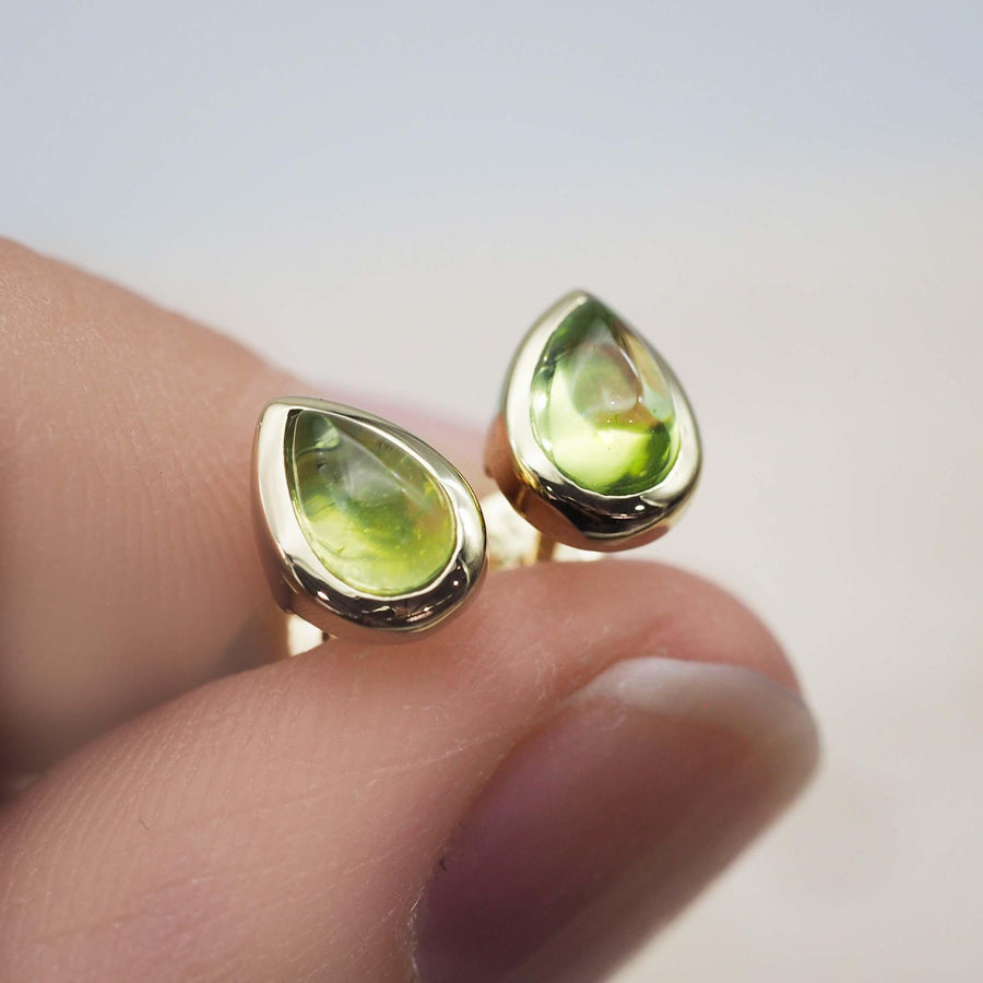 fingers holding gold August Birthstone Earrings - gold Peridot earrings - womens august birthstone jewellery australia
