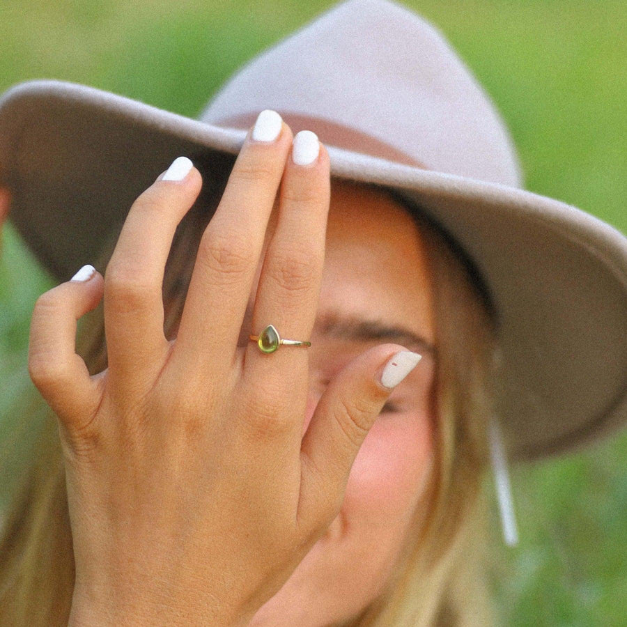 Woman wearing a hat and a August Birthstone Ring - Peridot jewellery - womens birthstone jewellery by indie and harper