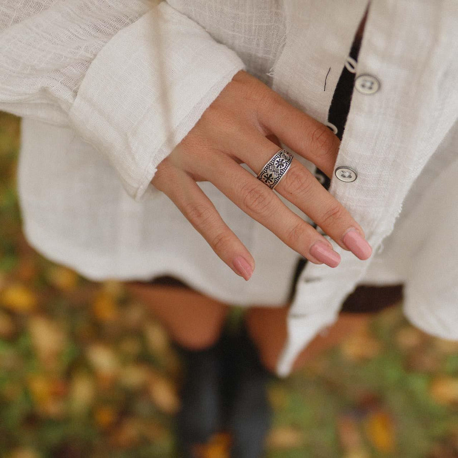 woman wearing white shirt and wearing sterling silver ring