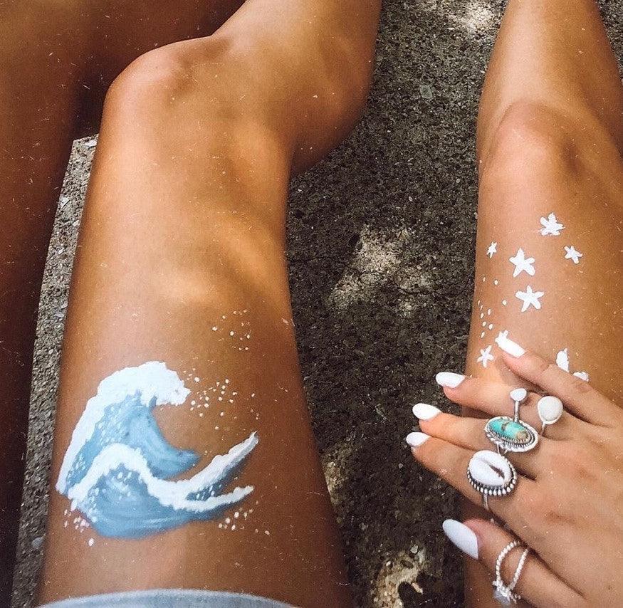 Girls leg with painted wave picture and wearing Cowrie Sea Shell Ring - womens sterling silver jewellery Australia