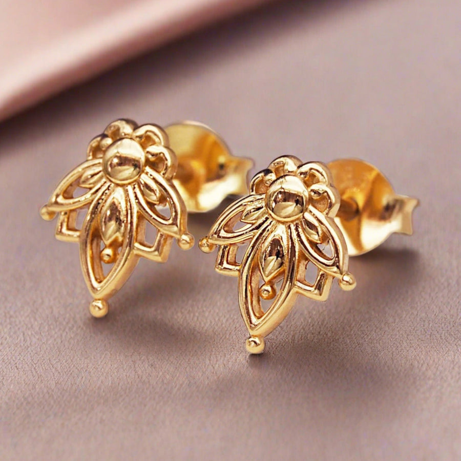 dainty gold earrings with lotus flower stud design