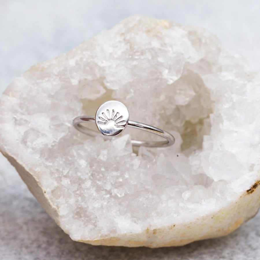 Sterling silver ring sitting in a white crystal