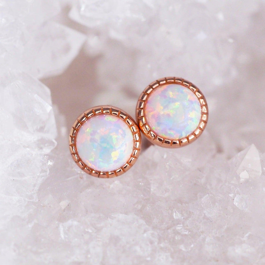 dainty rose gold earrings with opals shining with rainbow colours sitting in clear crystal - womens jewellery by indie and harper