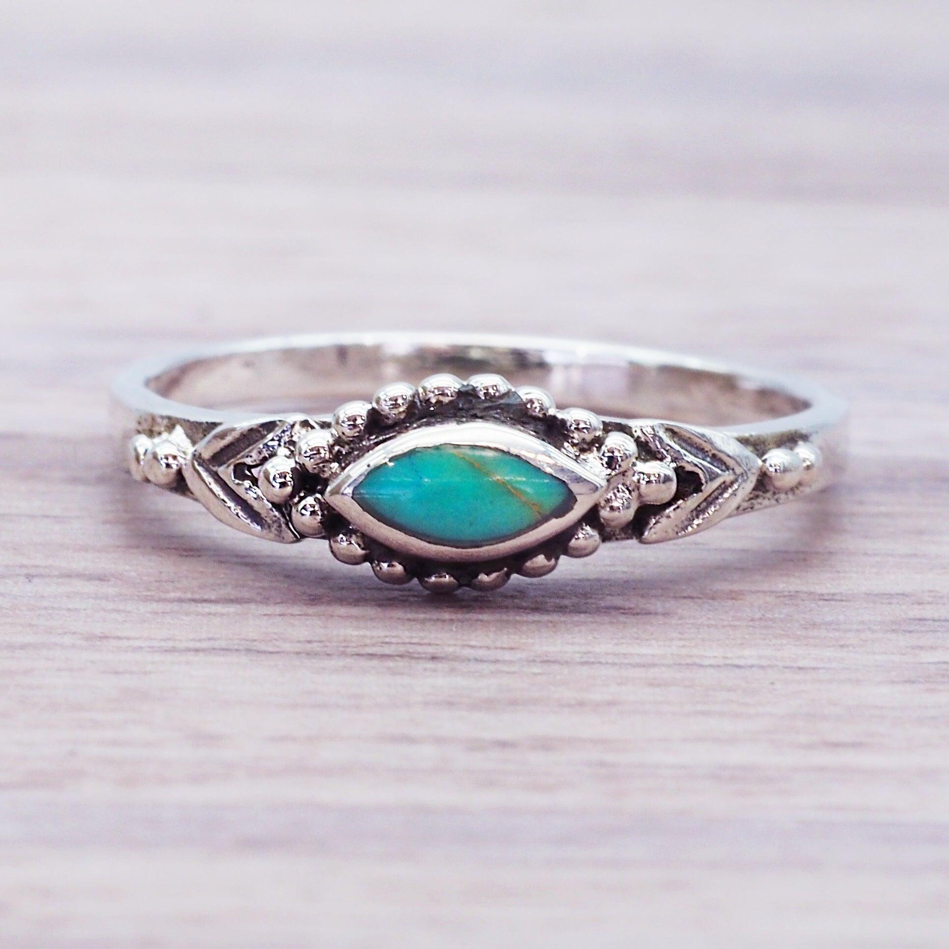 Sterling Silver ring with a marquise-shaped blue green turquoise stone with detailed boho design