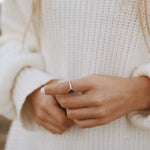 Sterling Silver February Birthstone Ring with a pear-shaped natural amethyst gemstone being worn as a meaningful birthstone jewellery gift for her