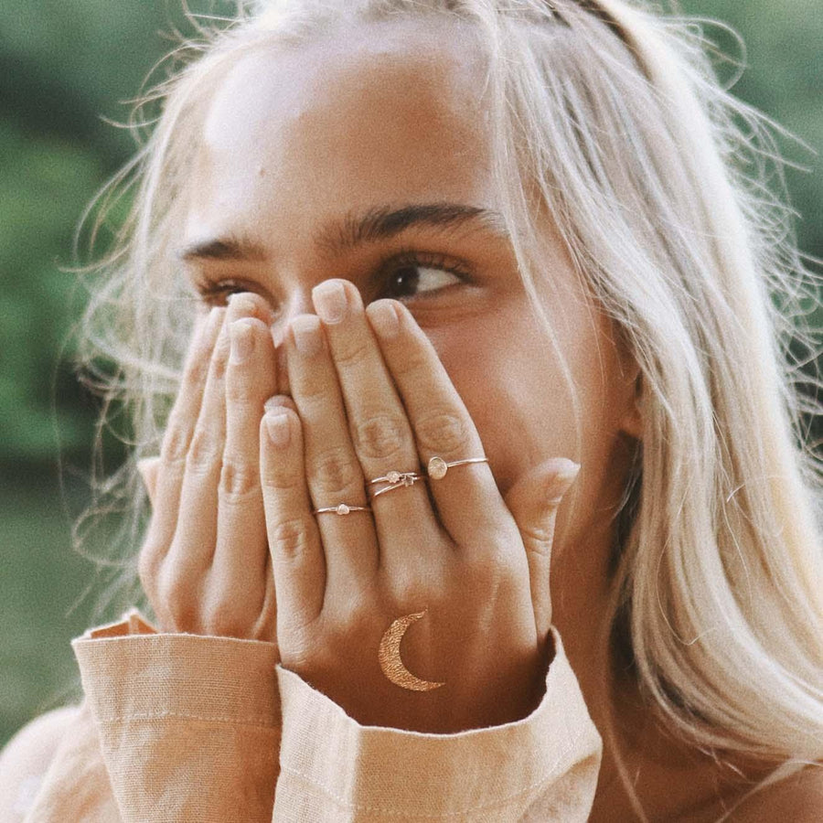 Woman with hands over face wearing Gold Dainty Rings - womens jewellery by indie and harper