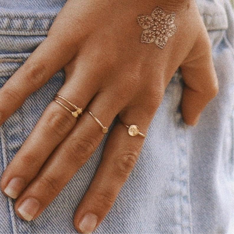 Woman’s hand on denim wearing dainty Gold Rings - womens gold jewellery Australia by indie and harper