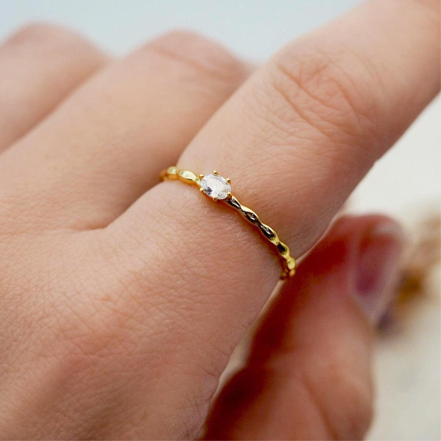 Finger wearing Dainty Gold Ring with white topaz crystal - womens gold jewellery by indie and harper