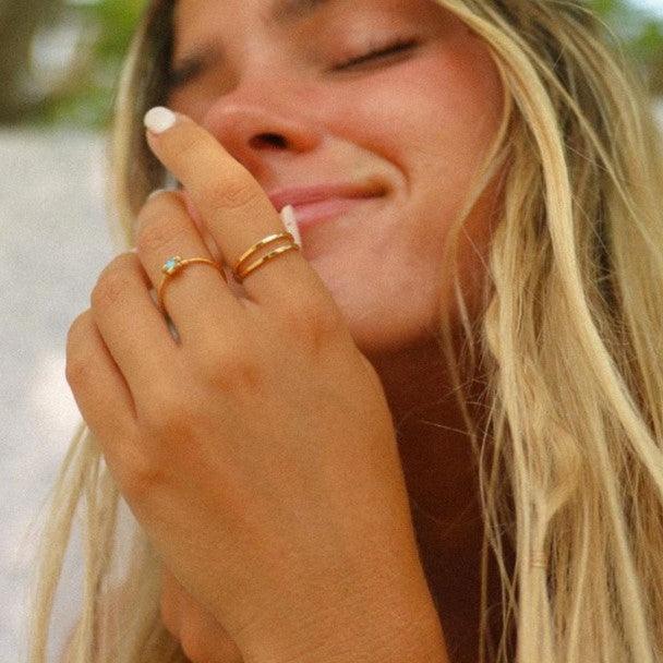 Woman wearing dainty Gold Rings by Australian jewellery brands indie and harper