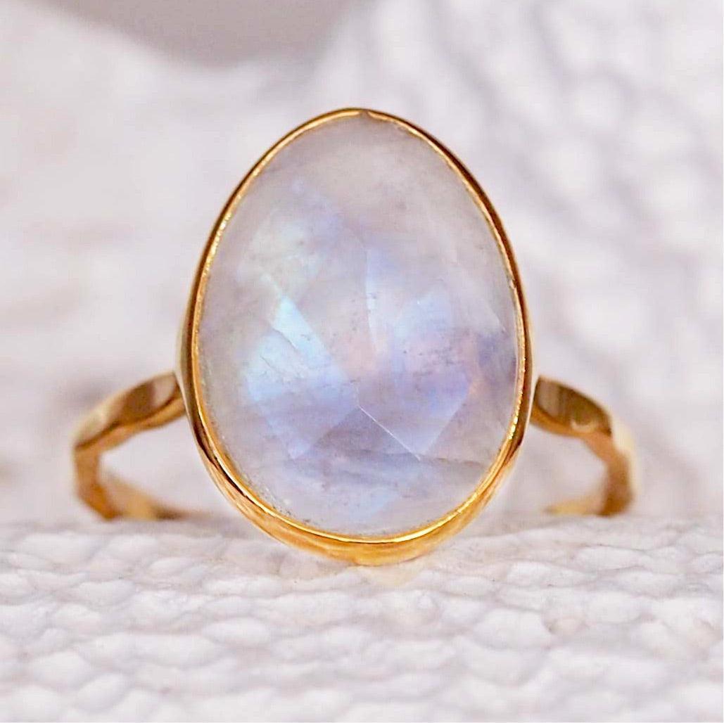 Statement Gold Rainbow Moonstone ring featuring large faceted stone on white textured backdrop