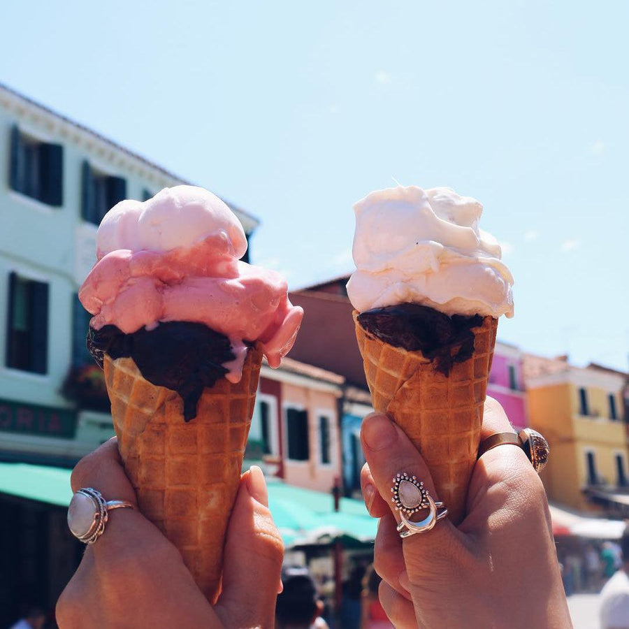 Hands holding ice creams and wearing moonstone rings