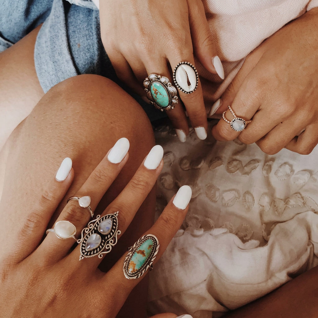 Navajo turquoise ring lifestyle photo of hands wearing boho silver rings