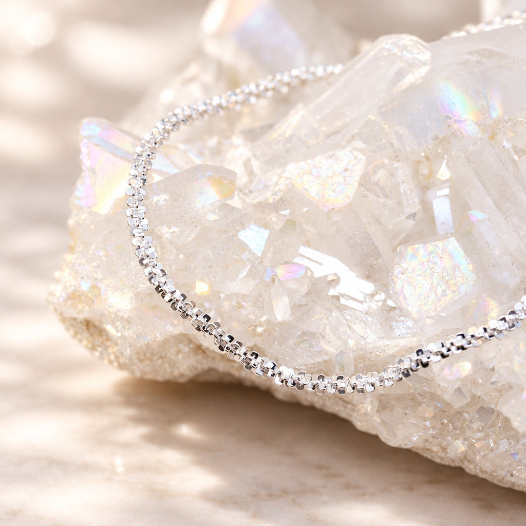 Sterling silver popcorn chain bracelet resting on a crystal