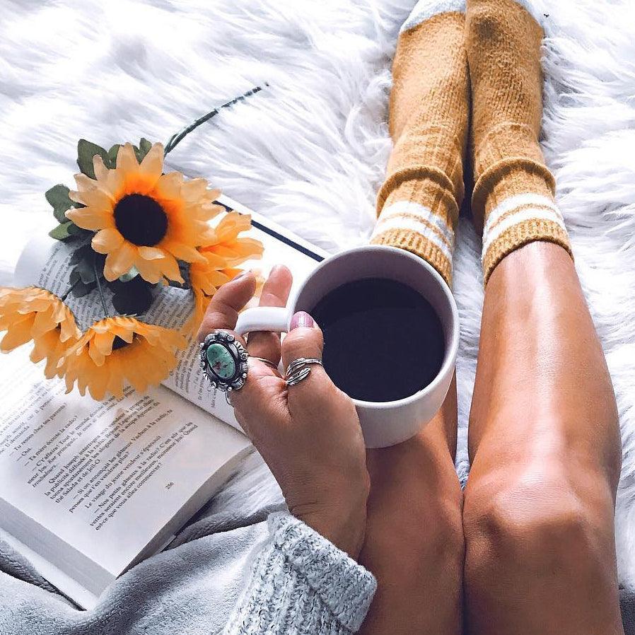 Woman in bed with coffee wearing Silver Navajo Jewelry - native american jewelry by womens jewelry brand indie and harper