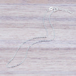 Italian Sterling Silver Anklet on a piece of light wood by indie and harper