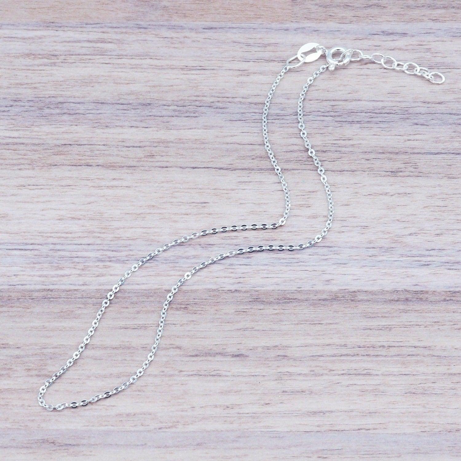 Italian Sterling Silver Anklet on a piece of light wood by indie and harper