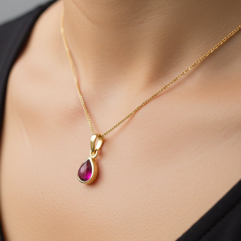 gold January Birthstone necklace with natural garnet gemstone pendant being worn as a January Birthday Gift