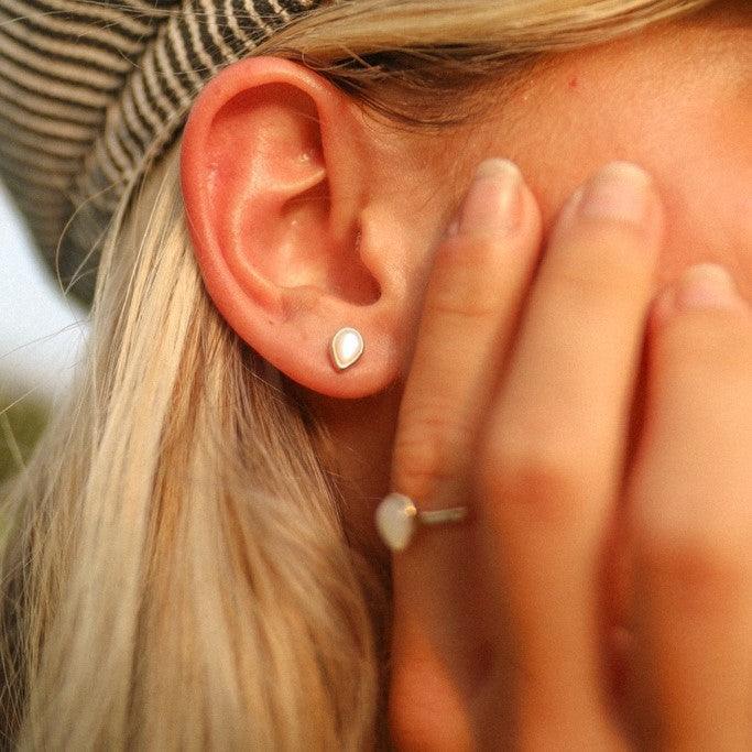 woman with blonde hair wearing Gold June Birthstone Pearl Earrings - indie and harper australia