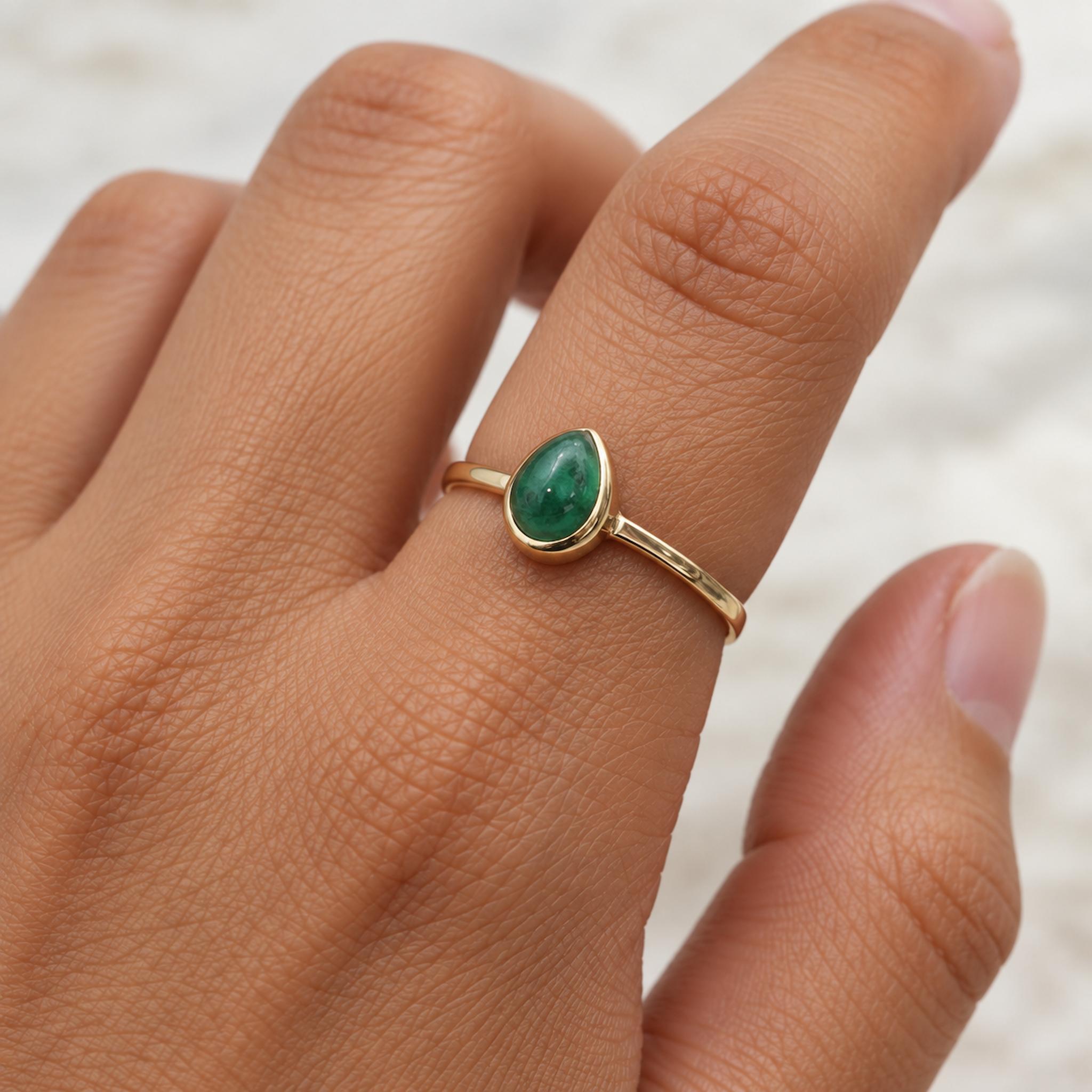 Gold may birthstone ring with natural emerald gemstone worn as a meaningful may birthstone jewellery gift for her