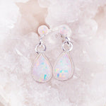 white Opal Earrings sitting on a crystal - opal jewellery by Australian jewellery brands indie and harper 