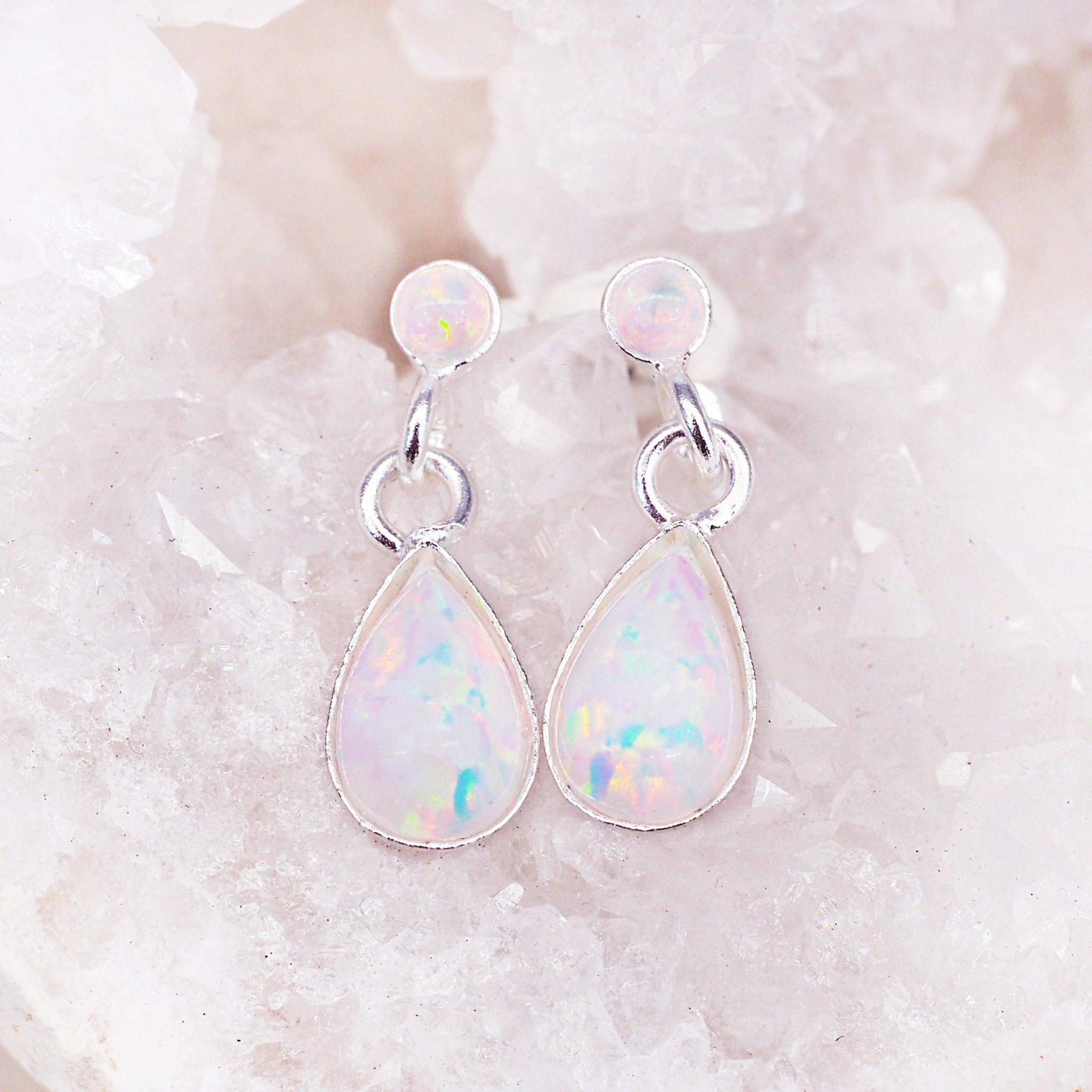 white Opal Earrings sitting on a crystal - opal jewellery by Australian jewellery brands indie and harper 