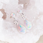 white Opal Earrings sitting on a crystal - opal jewellery by Australian jewellery brands indie and harper 