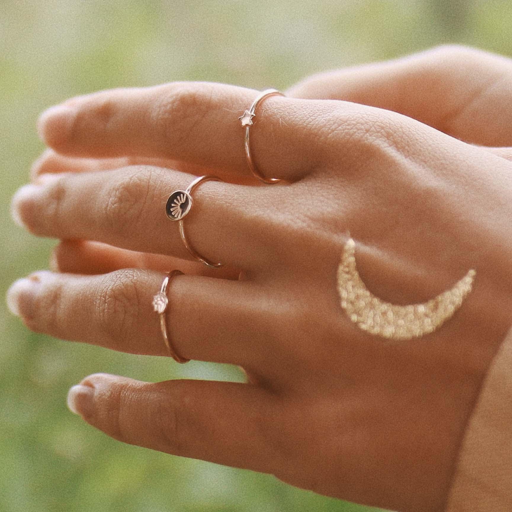 Woman with gold temporary tattoo on her hand and wearing Dainty Gold Rings - gold jewelry by womens jewelry brand indie and harper