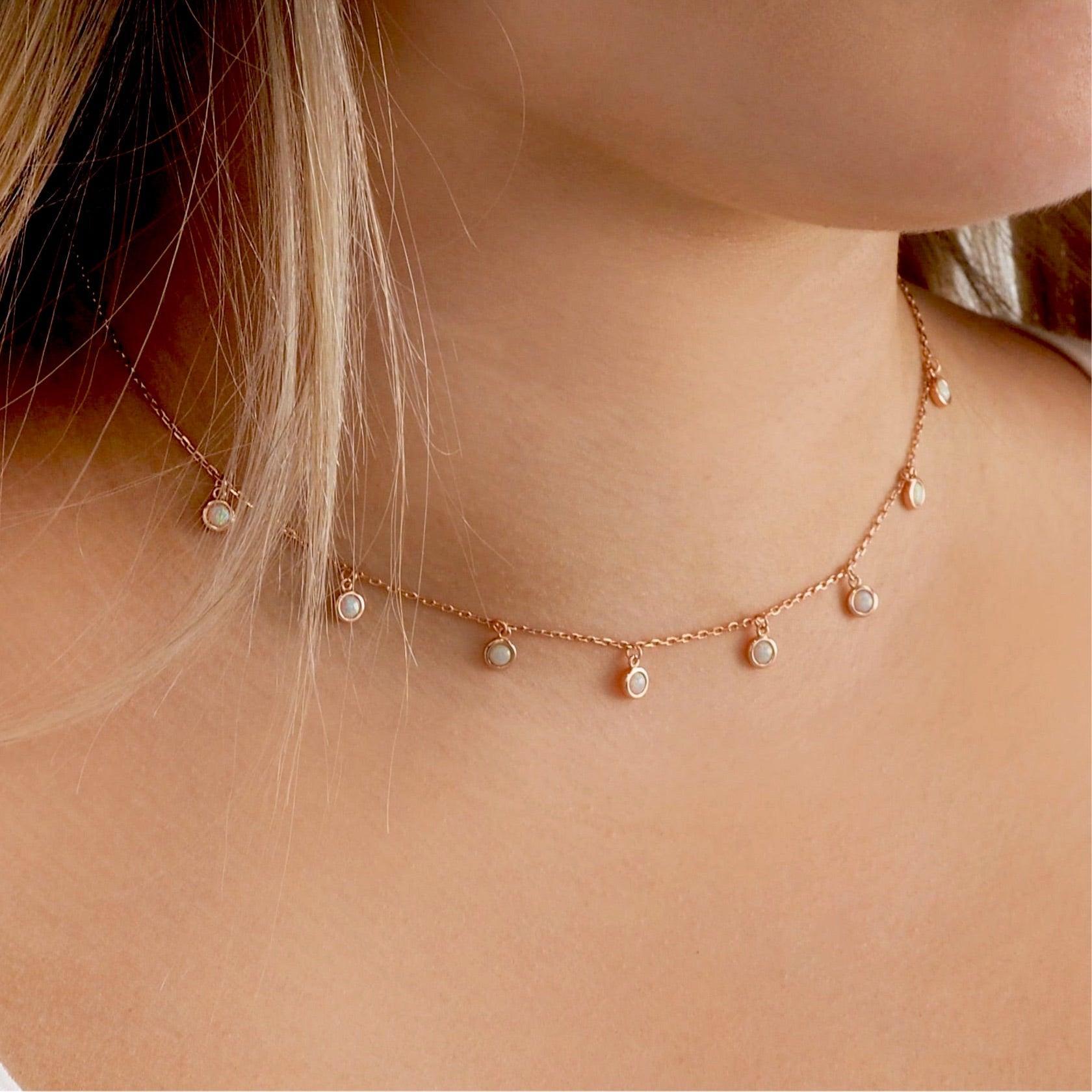 Dainty moonlight opal rose gold necklace being worn - indie and harper australia