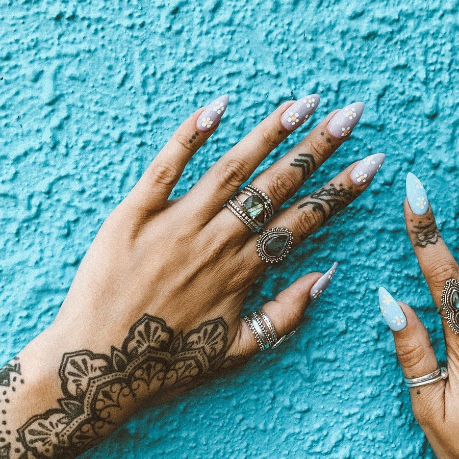 Woman’s hand with tattoos wearing Labradorite Rings - labradorite jewellery