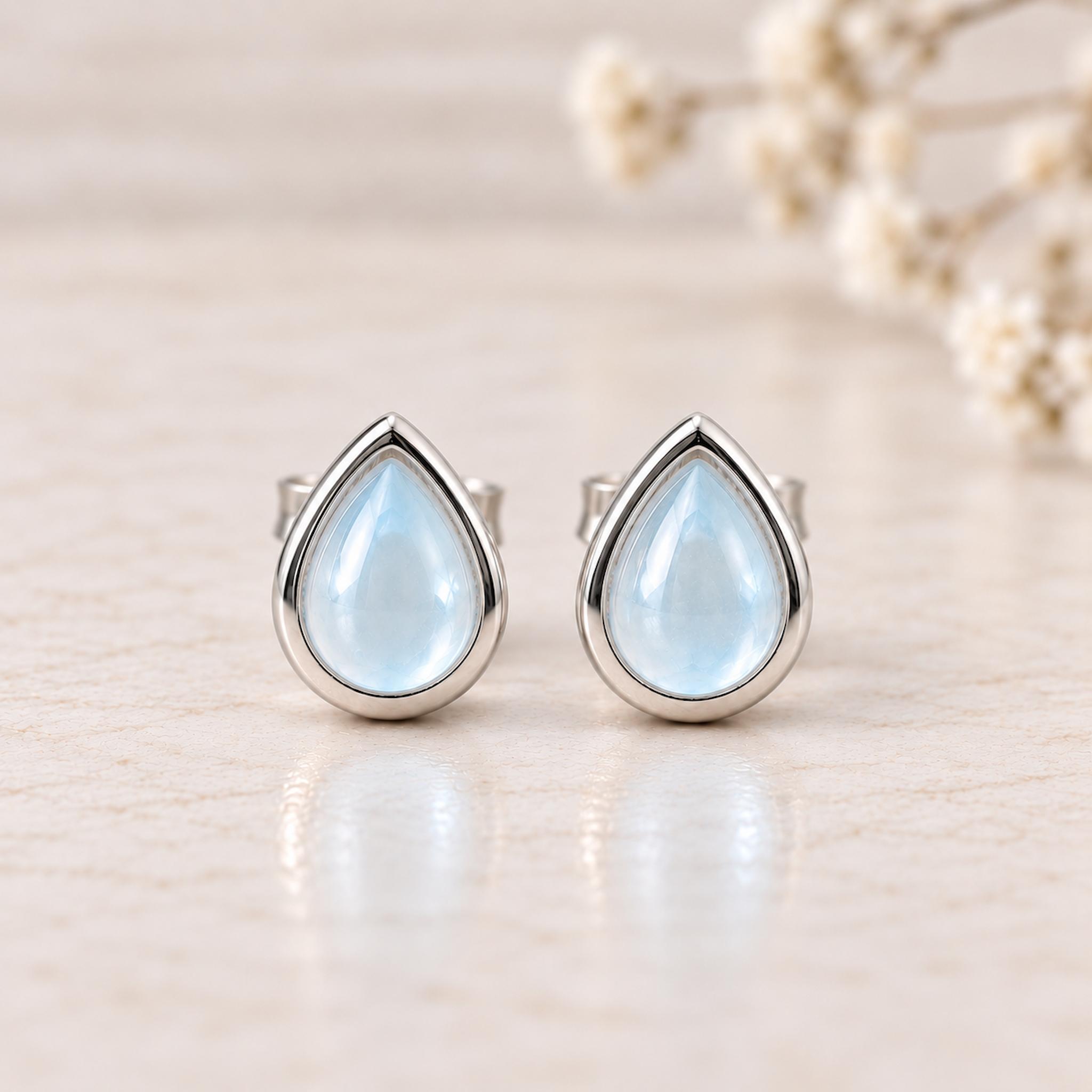 Sterling Silver November Birthstone Earrings with pear-shaped natural blue topaz gemstones