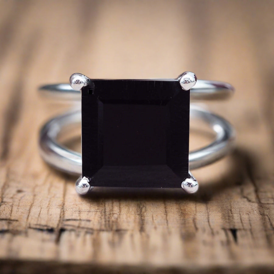 Sterling Silver Square Black Onyx Ring on a piece of rustic wood