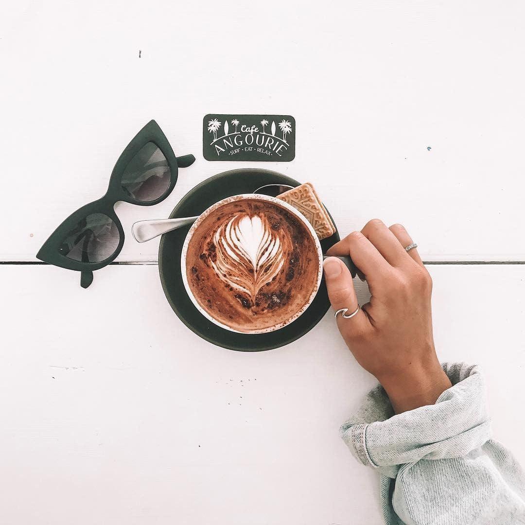 woman wearing sterling silver wave ring with coffee and sunglasses - indie and Harper