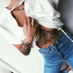 woman with tattoos wearing Solid 9k Gold Wave Ring - solid gold rings by womans jewelry brand indie and harper